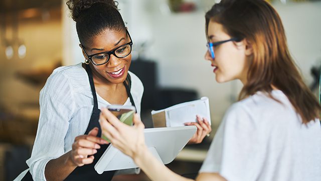 customer using coupon app on smartphone at restaurant